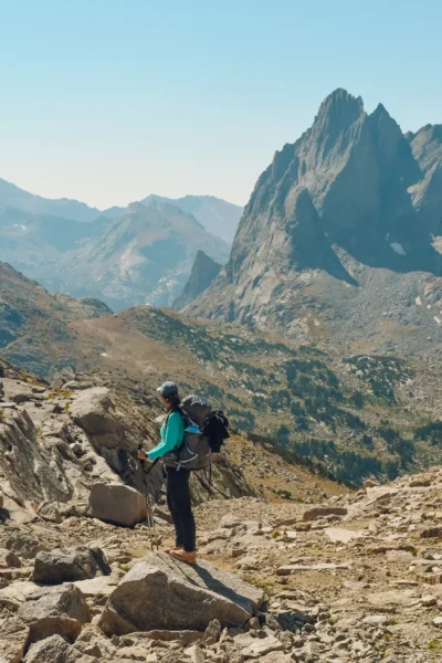 woman standing on a mountain with backpack on