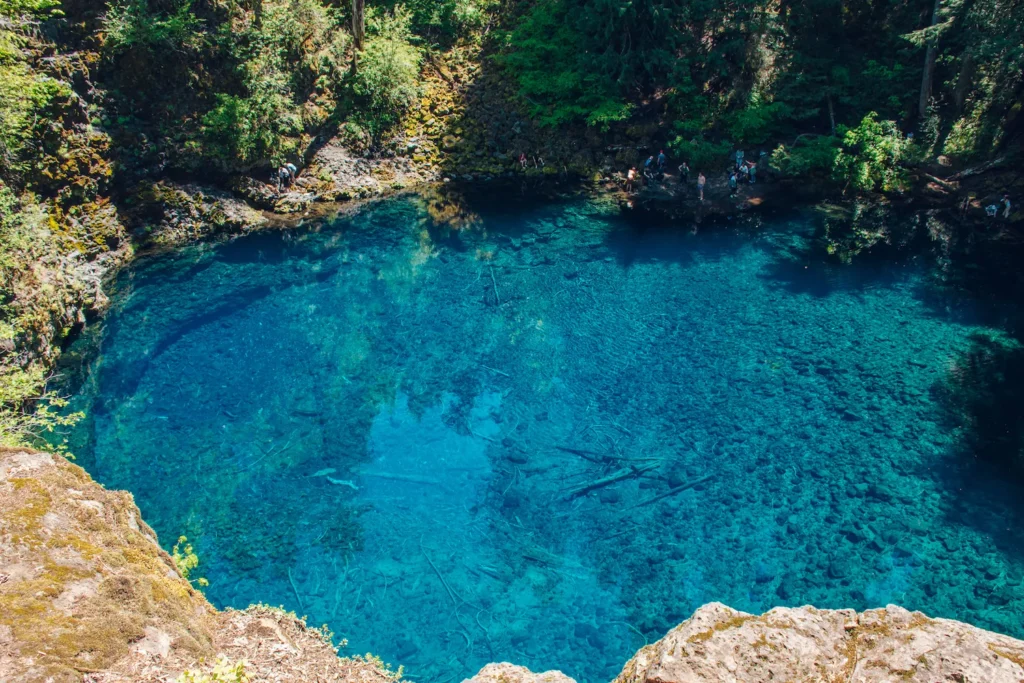 deep clear blue pool surrounded by cliffs