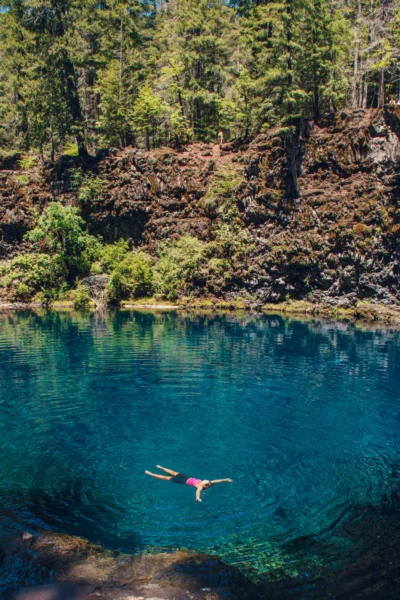 woman floats in blue pool, tamolitch falls blue pool