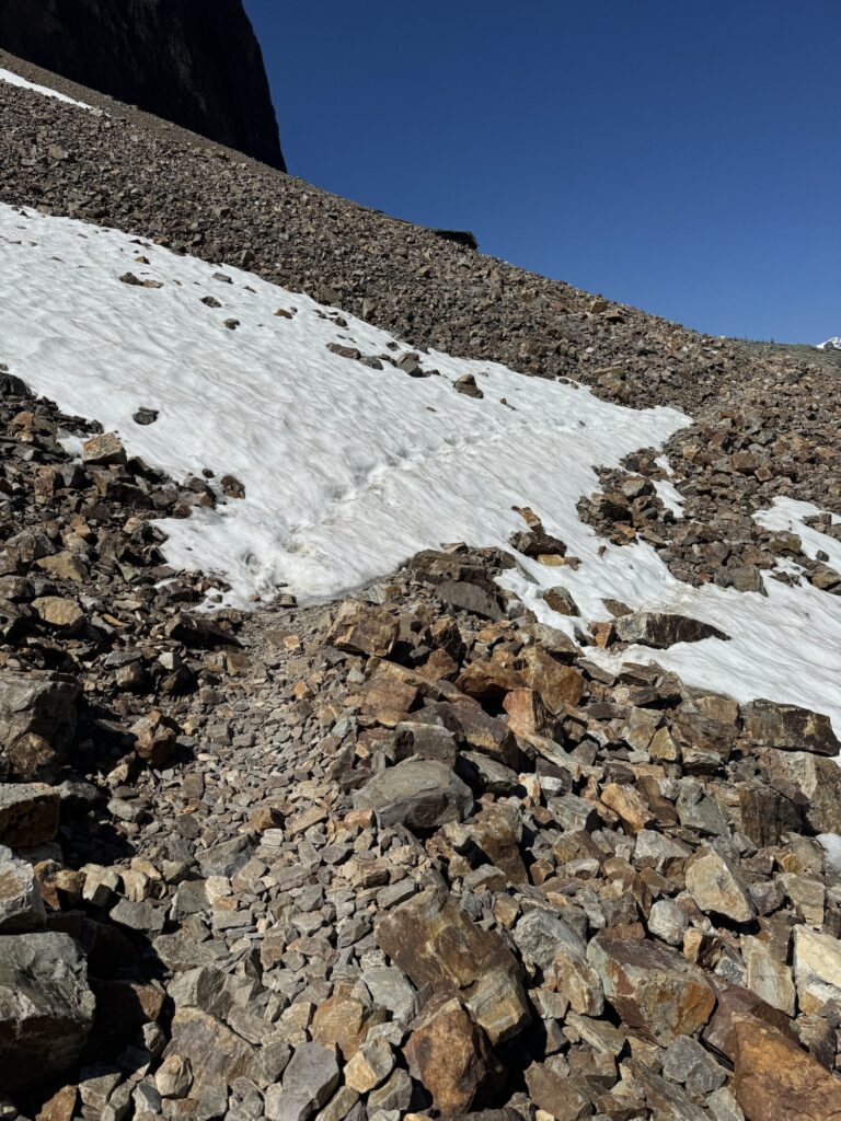 snow covering path on the trail on the alpine circuit in july