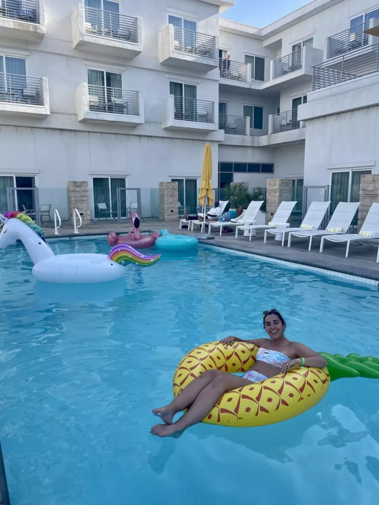 Girl relaxing on inner tube in Palm Springs pool