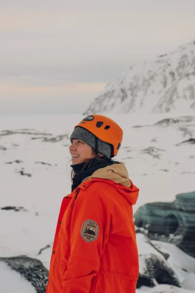 Woman smiling in a hat and helmet in Iceland