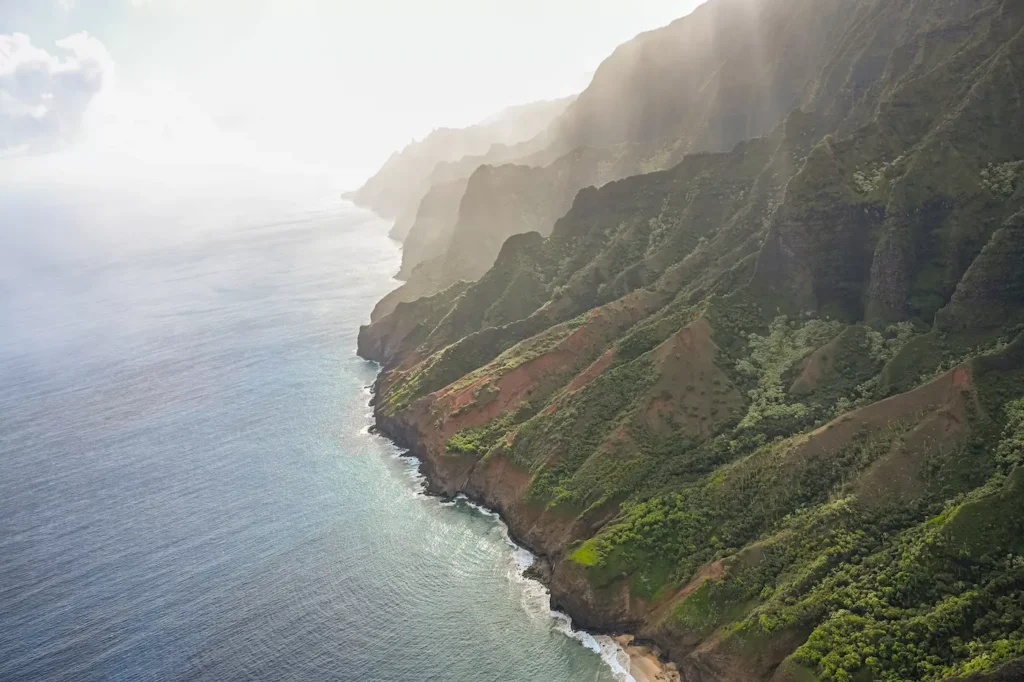 Napali coast from above with sun beams, on the flight into Kauai for the week
