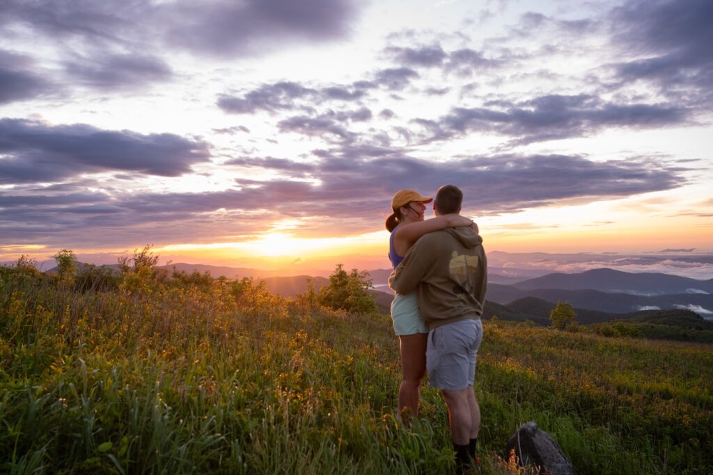 couple embracing on the top of Black Balsam Knob