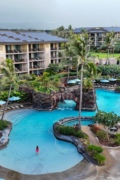 woman standing in pool of hotel in kauai