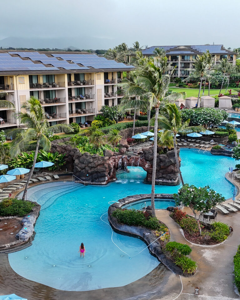 woman standing in pool of hotel in kauai