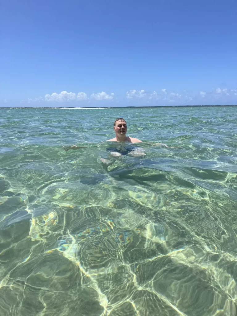 Guy chilling in Ke'e beach clear water