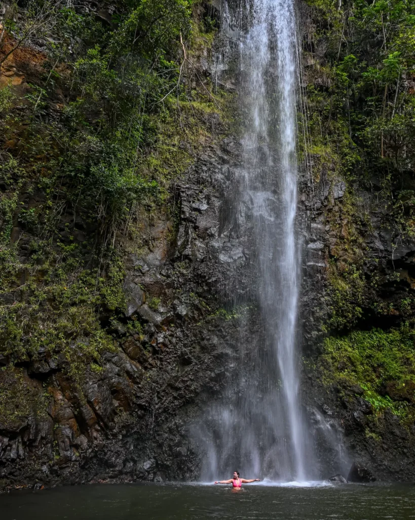 woman standing under Secret Falls