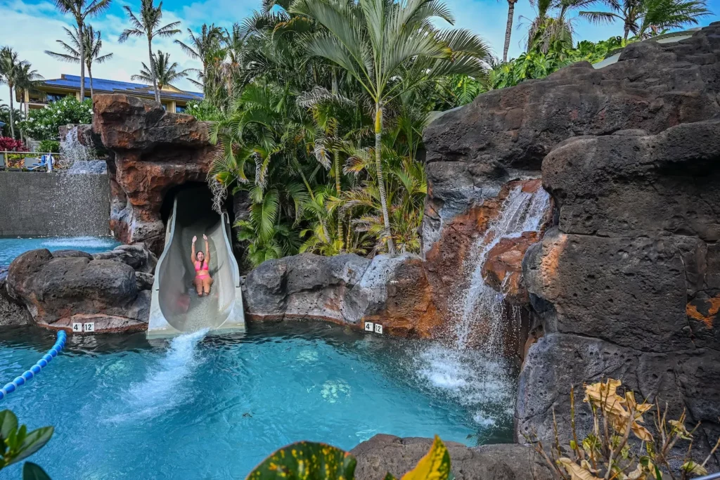 girl going down water slide koloa