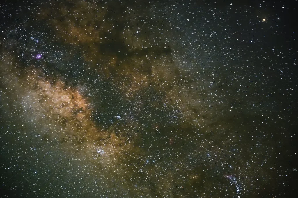 sky full of stars above volcanoes
