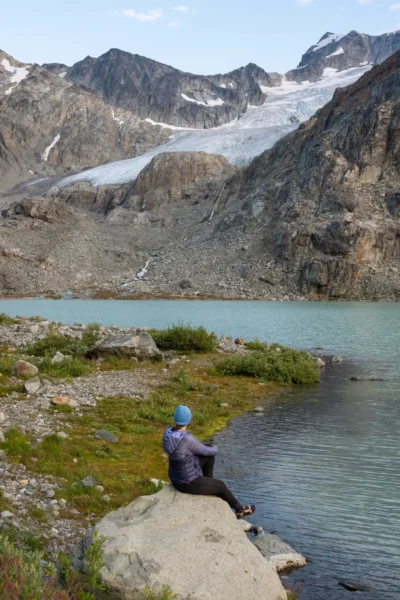 Woman sitting at Wedgemount lake