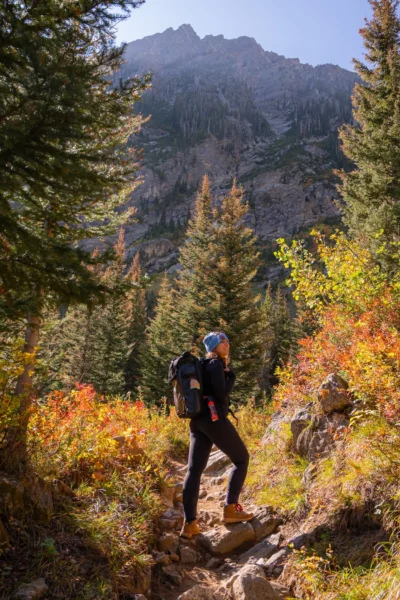 woman on paintbrush canyon trail, looking up and smiling
