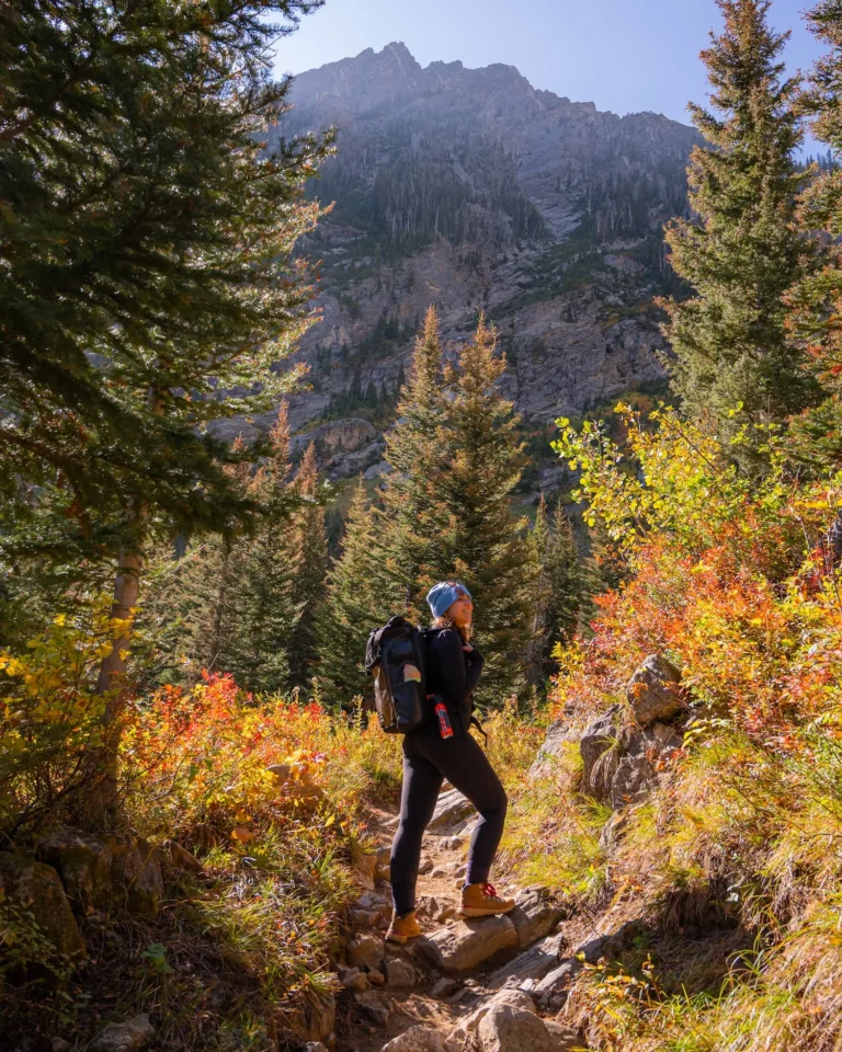 woman on paintbrush canyon trail, looking up and smiling