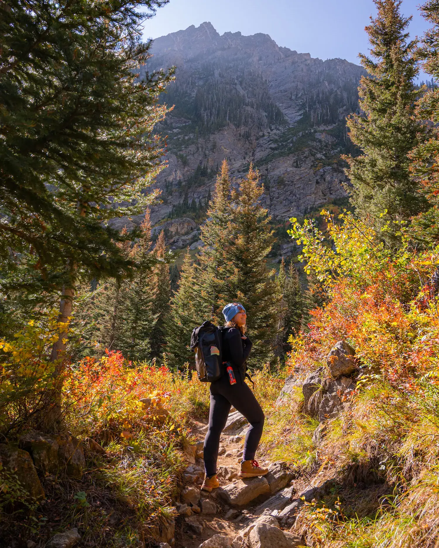 woman on paintbrush canyon trail, looking up and smiling
