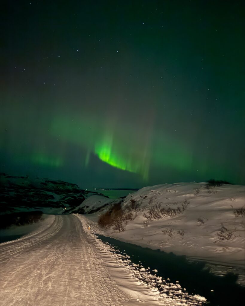 Northern Lights above an ice covered road in Iceland