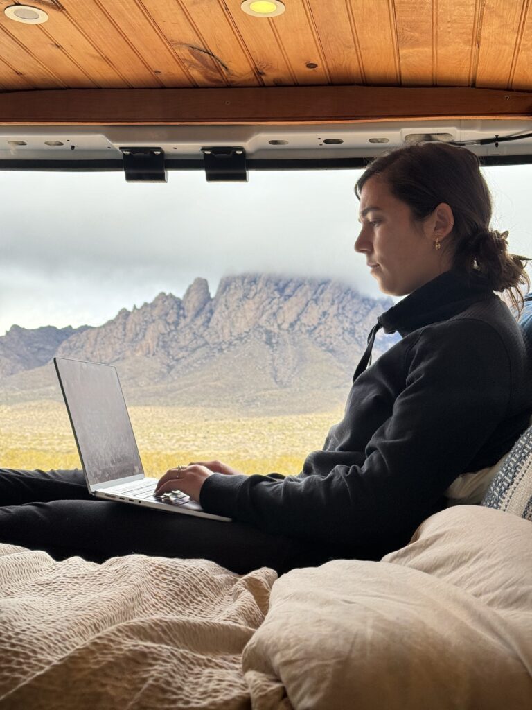 girl on her computer in a van