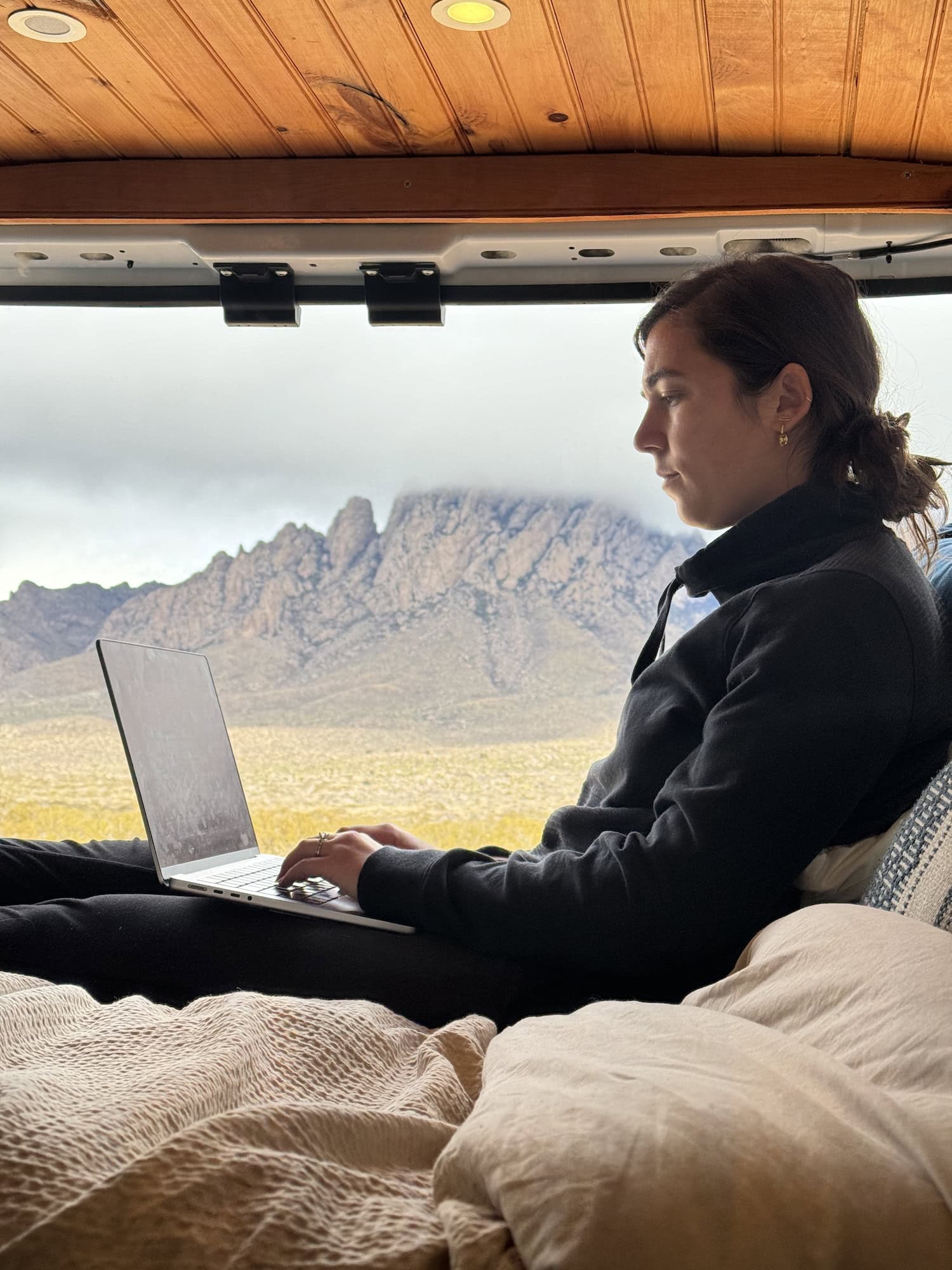 girl on her computer in a van