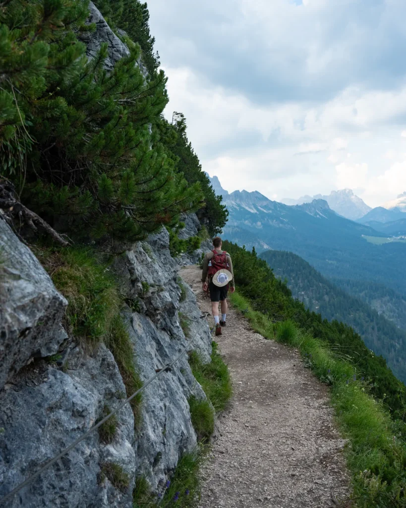 Guy walking on narrow ledge of Lake Sorapis hike