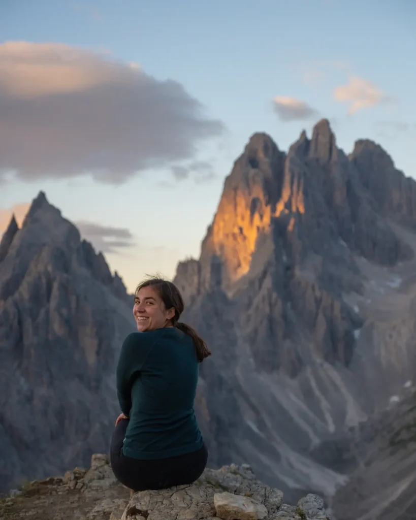 Girl looking back at the camera with cadini di misurina behind