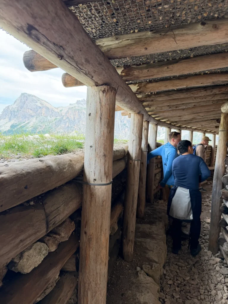 Trenches with people walking through them and mountains behind