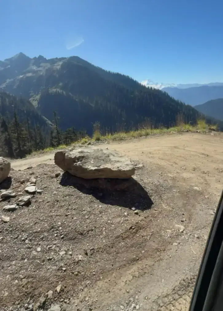 road view over mountains with mt baker in the back